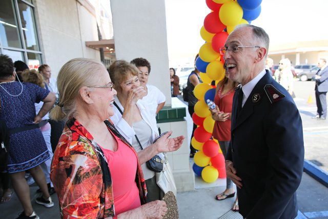 Commissioner Kenneth G. Hodder greets shoppers at Torrance Family Store reopening