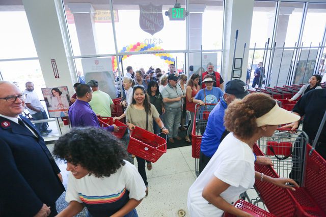 Enthusiastic shoppers enter Torrance Family Store during its reopening