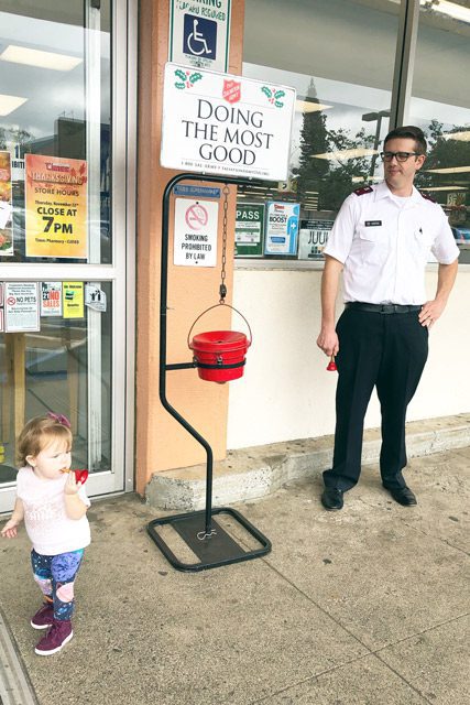 Kettle Bell Ringer in Front of Store